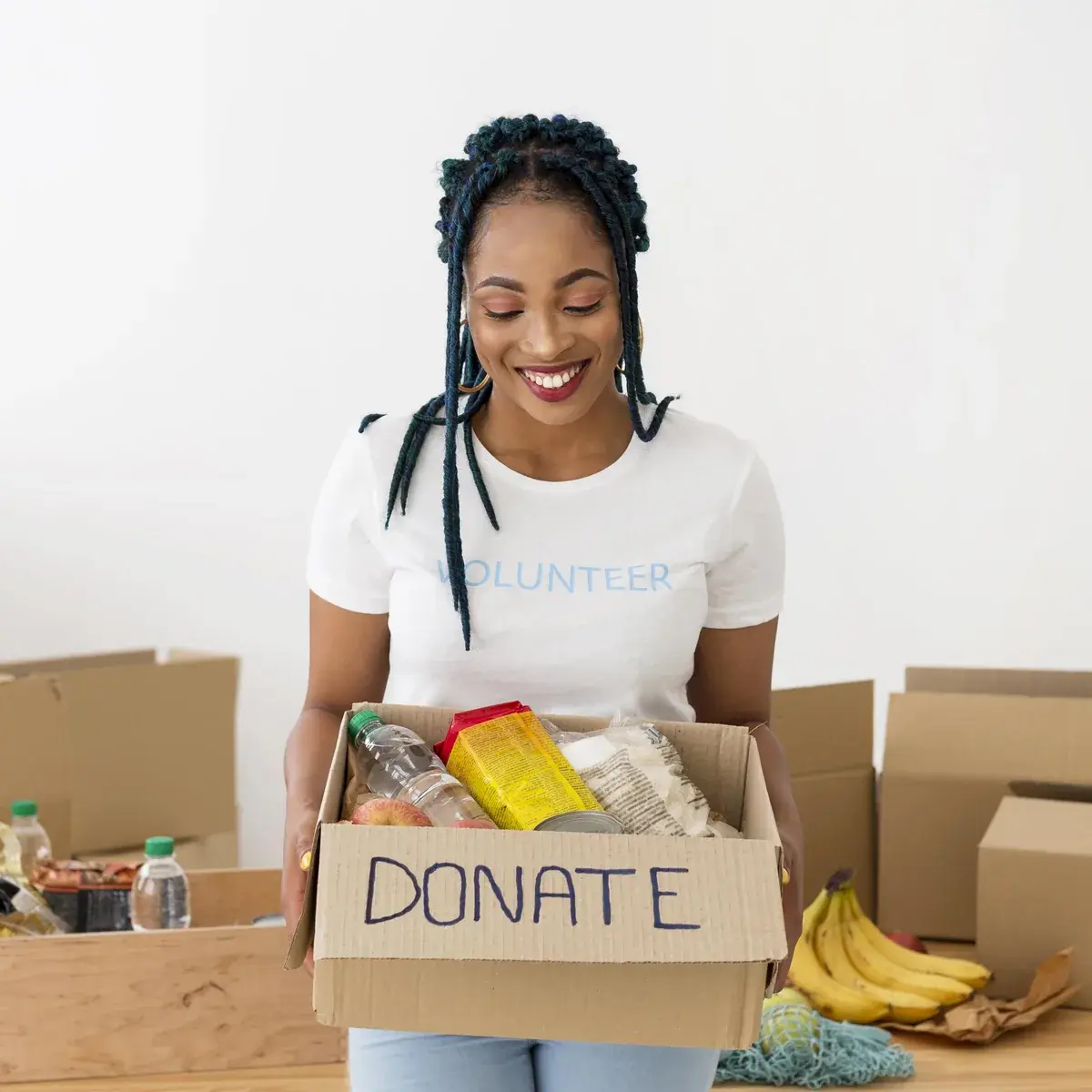 A volunteer packing a donation box