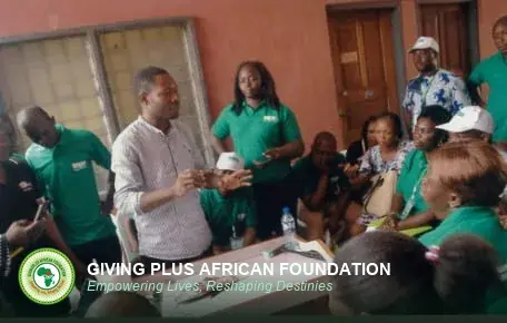 A facilitator standing and addressing seated trainees