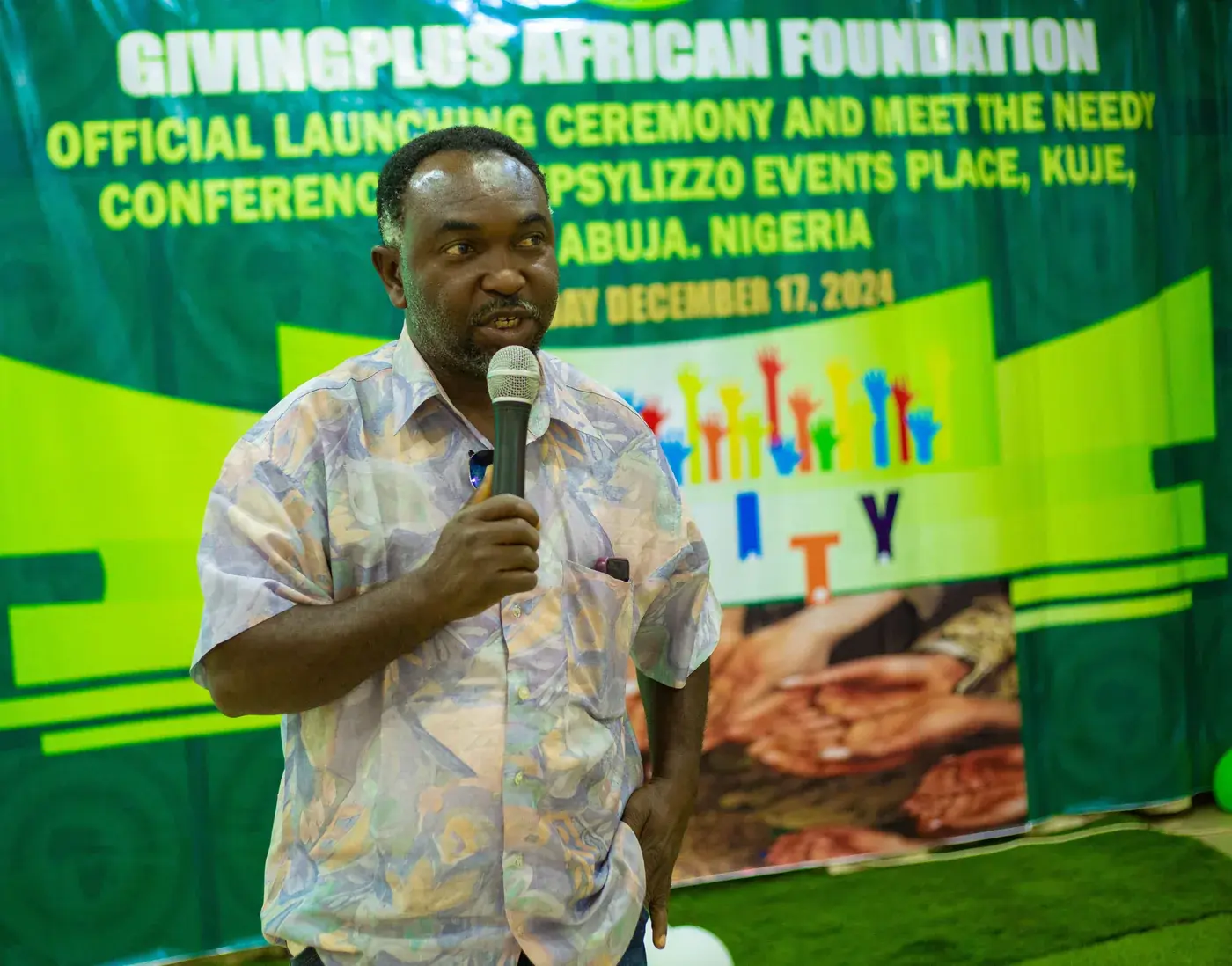 A speaker with a microphone at the launch conference